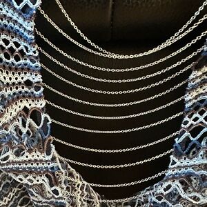 Alberto Malaki crochet swim cover with chain back design.